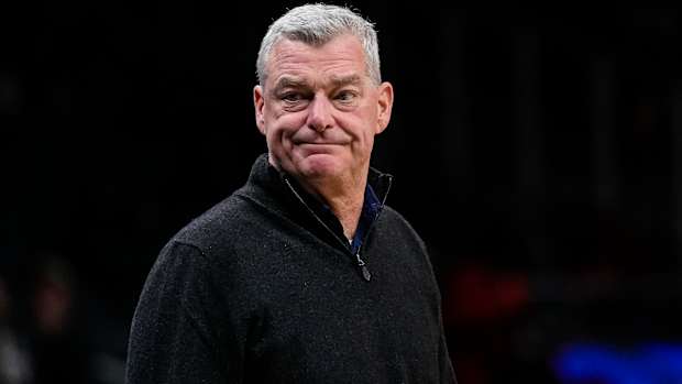 Tony Ressler stands courtside.